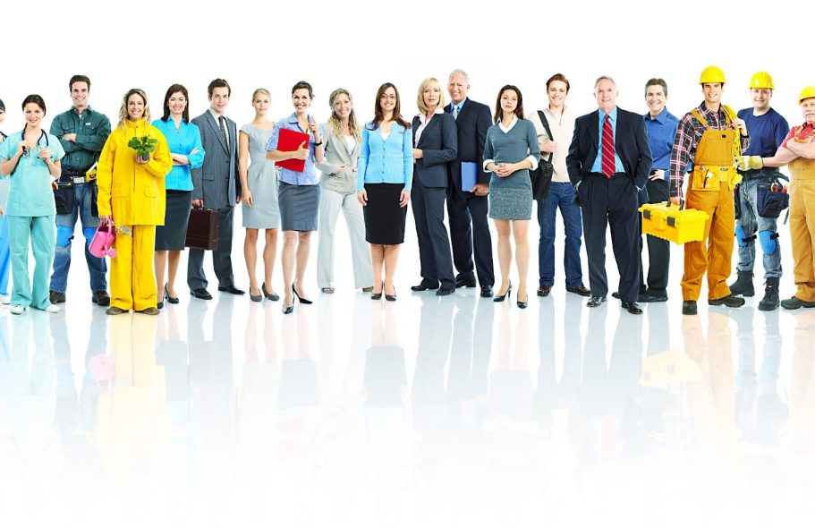 Groupe diversifié de professionnels en tenue de travail et formelle, posant ensemble.